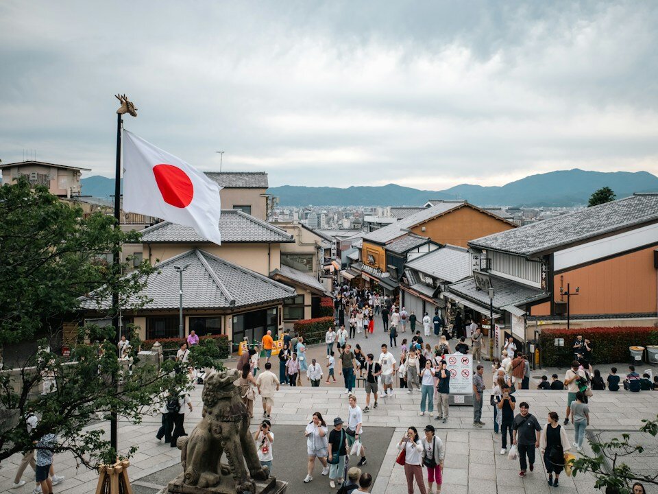 Japanese flag overlooks a busy city street