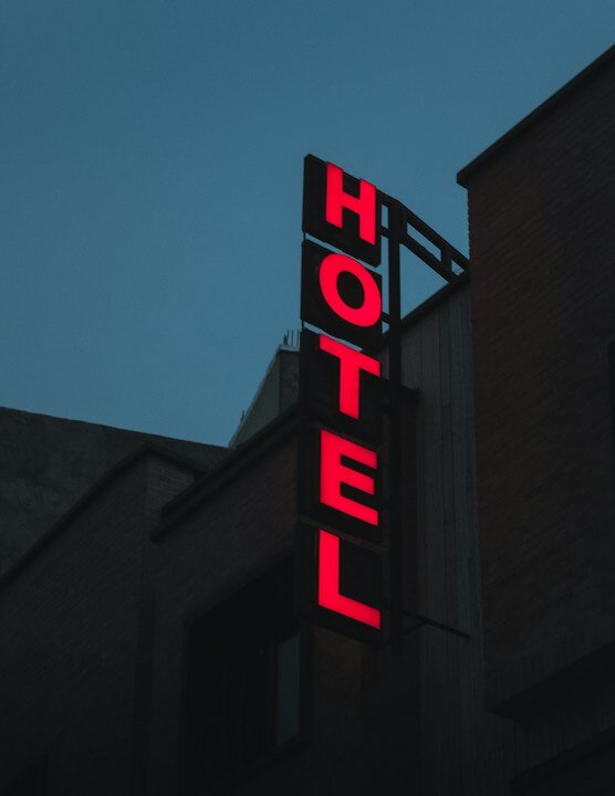 a red hotel sign on the side of a building